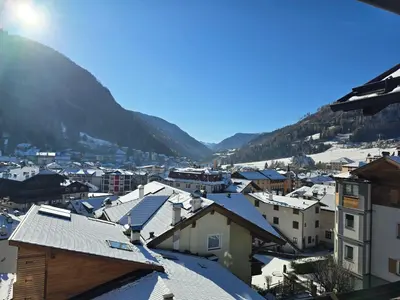 a view of a town with snow covered roofs at Le Vette di Moena - Alpine Stay Apartments in Moena