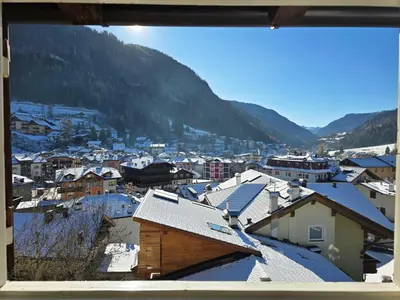 a view of a town with snow covered roofs at Le Vette di Moena - Alpine Stay Apartments in Moena