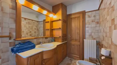 a bathroom with a sink and a mirror at Homeby, Casa Due Vette in Cortina dʼAmpezzo
