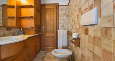 a bathroom with a toilet and a sink at Homeby, Casa Due Vette in Cortina dʼAmpezzo