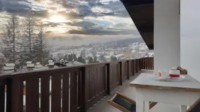 a balcony with a view of a city at Homeby, Casa Due Vette in Cortina dʼAmpezzo