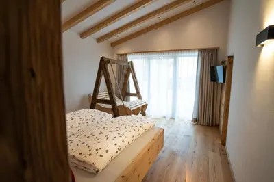 a bedroom with a bed and a large window at Lanzenschuster in San Genesio Atesino