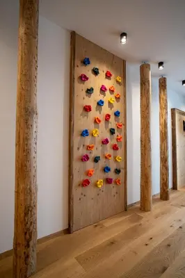 a climbing wall in a room with shoes on the wall at Lanzenschuster in San Genesio Atesino