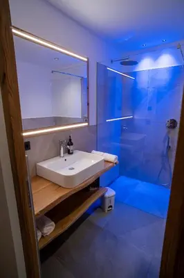 a bathroom with a sink and a shower at Lanzenschuster in San Genesio Atesino
