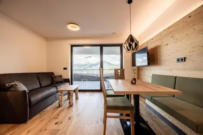 a kitchen and dining room with a table and chairs at Stabingerhof Chalets & Apartment-Farm stay in Bressanone