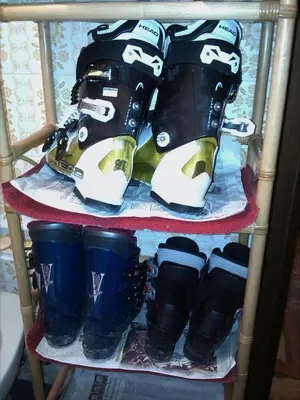a rack of ski boots and boots on a shelf at Licia in Canazei