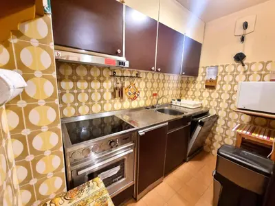 a kitchen with a sink and a stove at Licia in Canazei