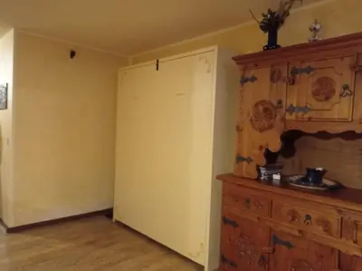 an empty room with a door and a dresser at Licia in Canazei