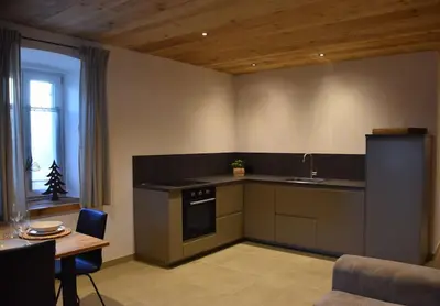 a kitchen with a table and a counter top at La casa dela Nona in Cavalese