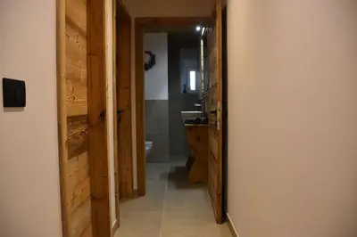 a hallway leading to a bathroom with a sink at La casa dela Nona in Cavalese