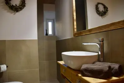 a bathroom with a sink and a mirror at La casa dela Nona in Cavalese