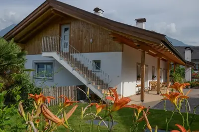 a house with a staircase in front of it at Kampflhof Apartments in Schenna