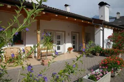 a patio of a house with flowers and plants at Kampflhof Apartments in Schenna