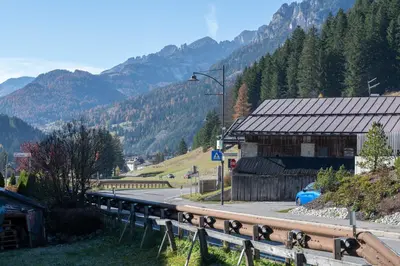 a view of a mountain with a building and a road at Cesa de Paio in Mazzin