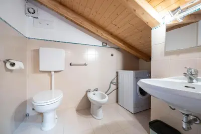 a bathroom with a toilet and a sink at Cesa de Paio in Mazzin
