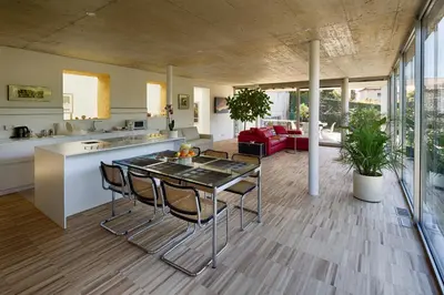 a kitchen and living room with a table and chairs at Villa Alvarium in Schenna