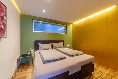 a bedroom with a large bed with a window at Villa Alvarium in Schenna
