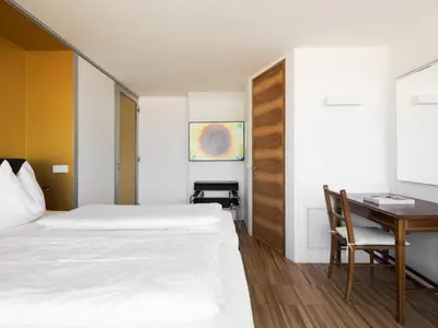 a bedroom with a bed and a desk and a table at Villa Alvarium in Schenna
