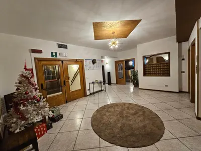 a living room with a christmas tree in the middle at TEA San Pellegrino - DOLOMITI in Falcade