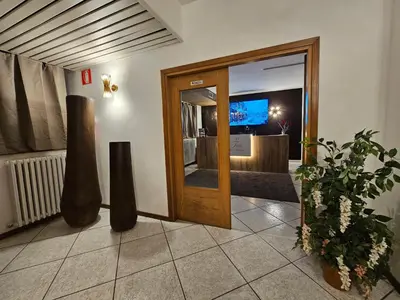 a lobby with a door and vases on the floor at TEA San Pellegrino - DOLOMITI in Falcade