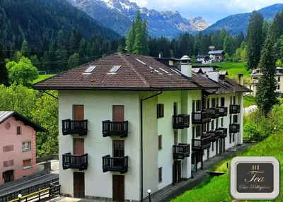 a building with balconies on the side of it at TEA San Pellegrino - DOLOMITI in Falcade