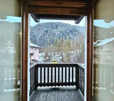 a bedroom with a bed and a wooden ceiling at TEA San Pellegrino - DOLOMITI in Falcade