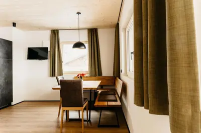 a dining room with a table and a window at Apartments Broslhof in Racines