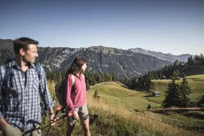 a man and a woman walking on a mountain at Apartments Broslhof in Racines