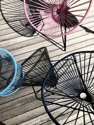 a group of umbrellas sitting on a wooden floor at Design Hotel Tyrol in Rablà