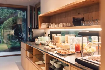 a kitchen with a counter with food on it at Pomella's Guesthouse in Cortaccia
