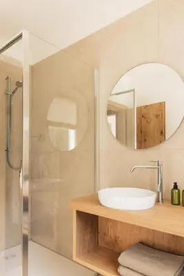a bathroom with a sink and a mirror at Pomella's Guesthouse in Cortaccia