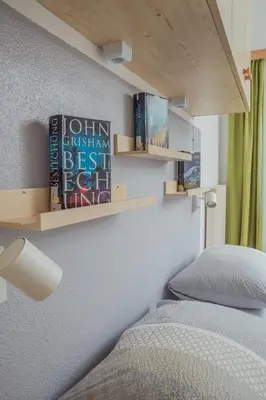 a large bed in a room with white walls and cabinets at Apartment - Alpin Chalet Frenademetz in San Martino in Badia