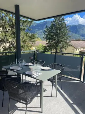 a table and chairs sitting on a balcony with a view at Terrazza Palade in Merano