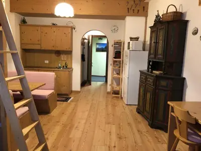 a room with a kitchen and a refrigerator at Casa Serenity in Falcade