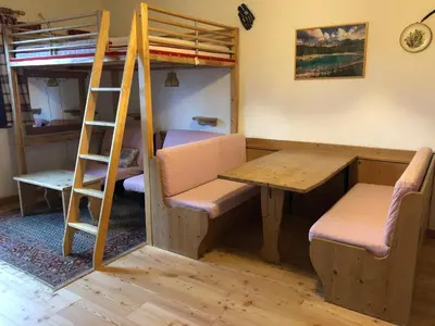 a room with a desk and a ladder and a bunk bed at Casa Serenity in Falcade
