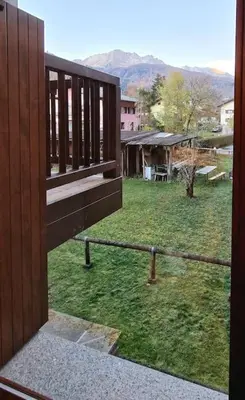 a view of a yard from a balcony of a house at trilocale panorama val di fiemme in Predazzo