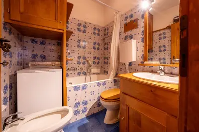 a bathroom with a toilet and a sink and a tub at GuestHost - Silent Peaks - Cortina's Wooden Haven in Cortina dʼAmpezzo