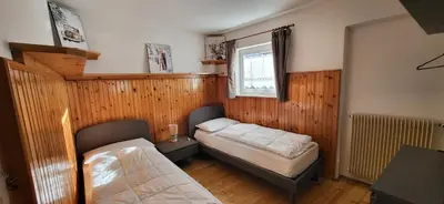 a bedroom with two beds and a window at Casa Clo' in Varena