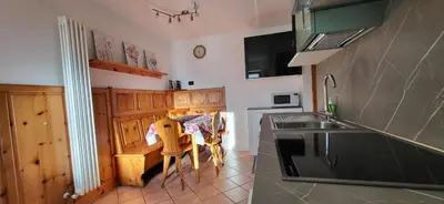 a kitchen with a sink and a table in it at Casa Clo' in Varena