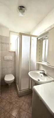 a bathroom with a shower and a toilet and a sink at Casa Clo' in Varena