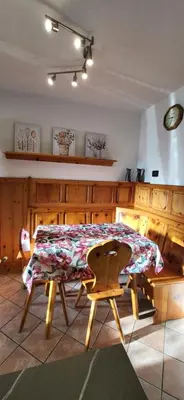 a kitchen with a table and a table and chairs at Casa Clo' in Varena