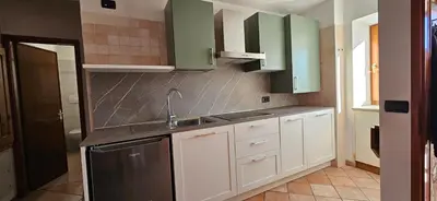 a kitchen with green cabinets and a sink at Casa Clo' in Varena