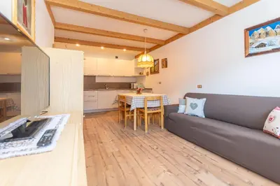 a living room with a couch and a table at Appartamento Lucia 203 in Vigo di Fassa