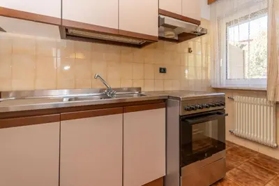 a kitchen with a sink and a stove at Appartamento Alessandra 106 in Vigo di Fassa