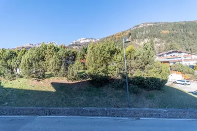 a street light on the side of a hill with trees at Appartamento Alessandra 106 in Vigo di Fassa