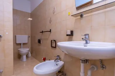 a bathroom with a sink and a toilet at Appartamento Alessandra 204 in Vigo di Fassa