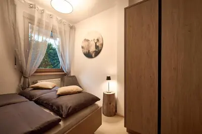 a bedroom with a bed and a window at Stadtnestl Apartment in Vipiteno