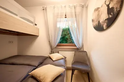 a small bedroom with a bed and a window at Stadtnestl Apartment in Vipiteno