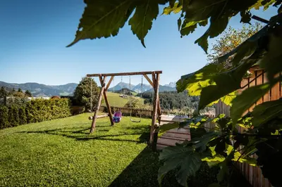 a swing set in the yard of a house at Ciasa Sabine in Antermoia