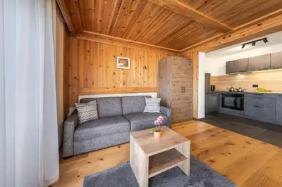 a living room with a couch and a table at Ciasa Sabine in Antermoia